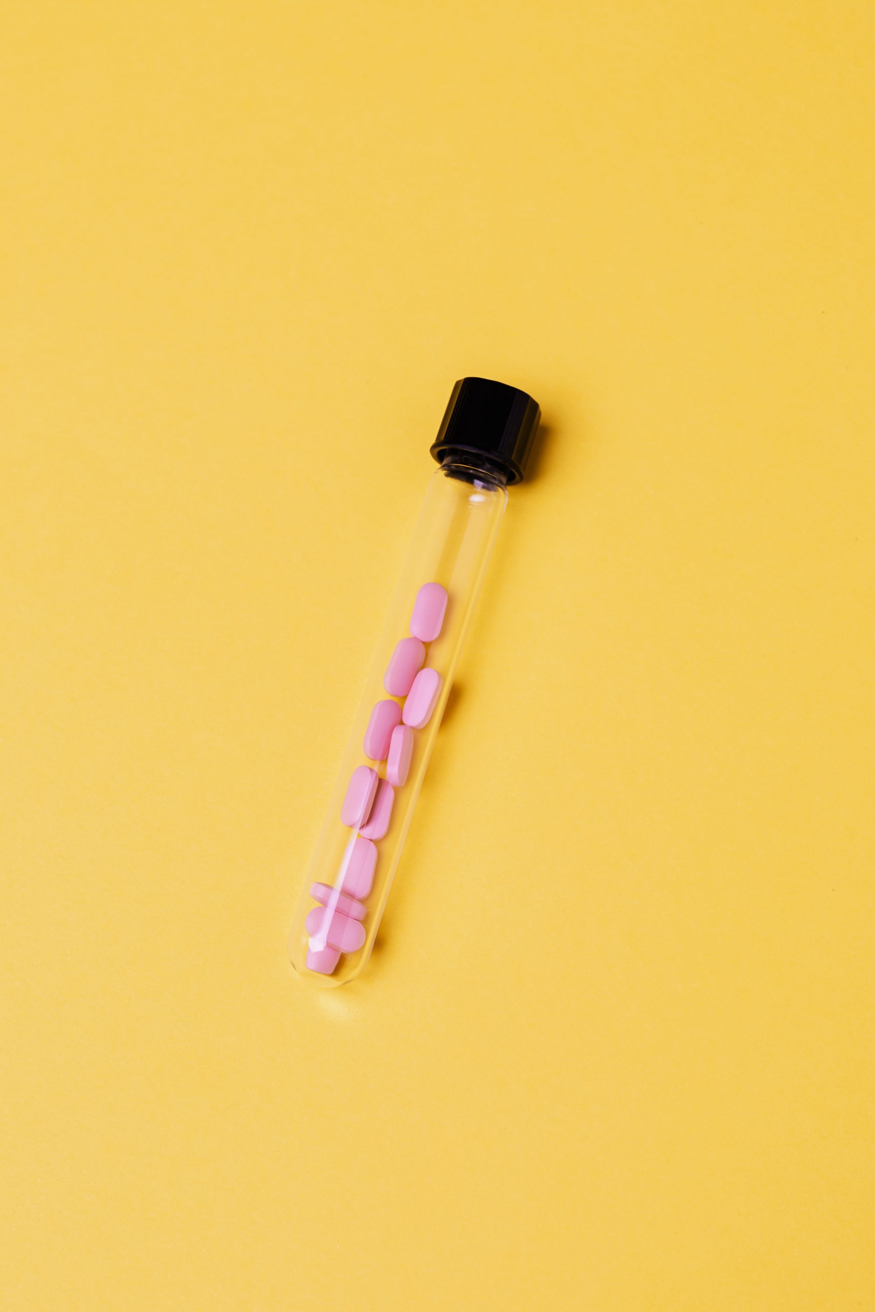 medicinal-tablets-inside-a-glass-tube-on-yellow-background-4047066 medicinal-tablets-inside-a-glass-tube-on-yellow-background-4047066